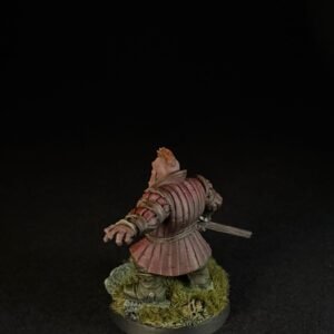 Back view of a medieval knight miniature in pinkish armor, with a sword at the side, standing on a grassy base.