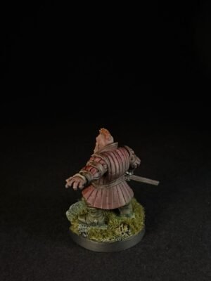 IMG_1505 Back view of a medieval knight miniature in pinkish armor, with a sword at the side, standing on a grassy base.