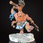 Miniature dwarf warrior with orange beard swinging a large battle axe on a snowy rocky base.