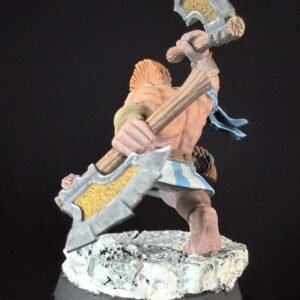 Fantasy miniature figure: a muscular warrior wielding a large double-headed war axe, standing on a rocky base with a blue sash fluttering behind him.