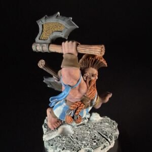Fantasy miniature barbarian warrior swung over his head with a large double-headed axe, standing on a rocky base, wearing blue fabric and brown leather.