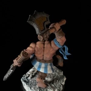 Fantasy miniature: muscular barbarian warrior with a large, rune-inscribed axe, blue scarf, and blue-and-white striped kilt, standing on a rocky base.