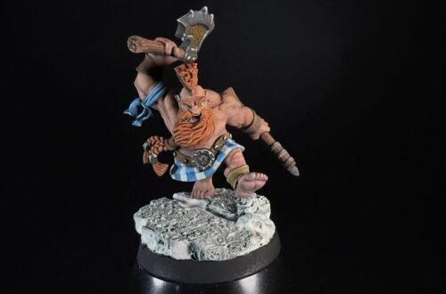 Painted dwarf barbarian miniature raising a battle-axe on a rocky base against a black background.