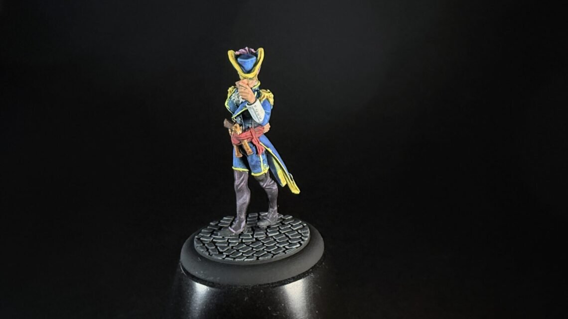 Colorful miniature pirate figure standing on a cobblestone base against a black background.