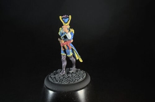 Colorful miniature pirate figure standing on a cobblestone base against a black background.