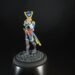 Colorful miniature pirate figure standing on a cobblestone base against a black background.