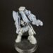 Gray plastic tabletop miniature of an armored warrior with a dragon-head mount, standing on a round base with a shield and weaponry visible.