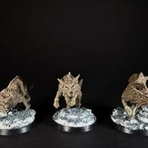 IMG_1836 Three fenrisian wolves miniatures standing on rocky, snow-covered against a black background, ready for tabletop gaming.