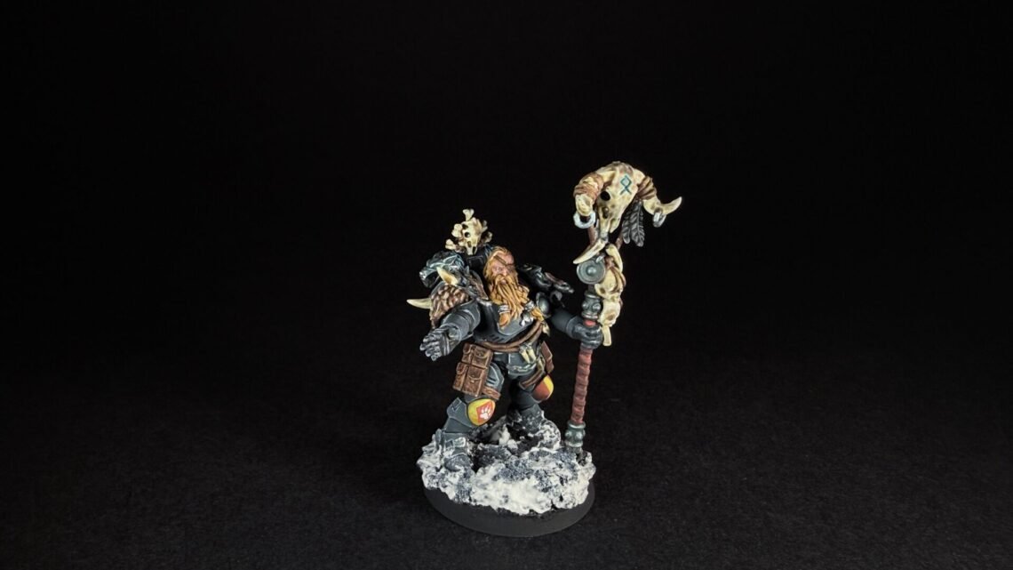 Painted Wolf Scout Rune Priest Skjald with Bolt Pistol and Runic Staff on snowy base.