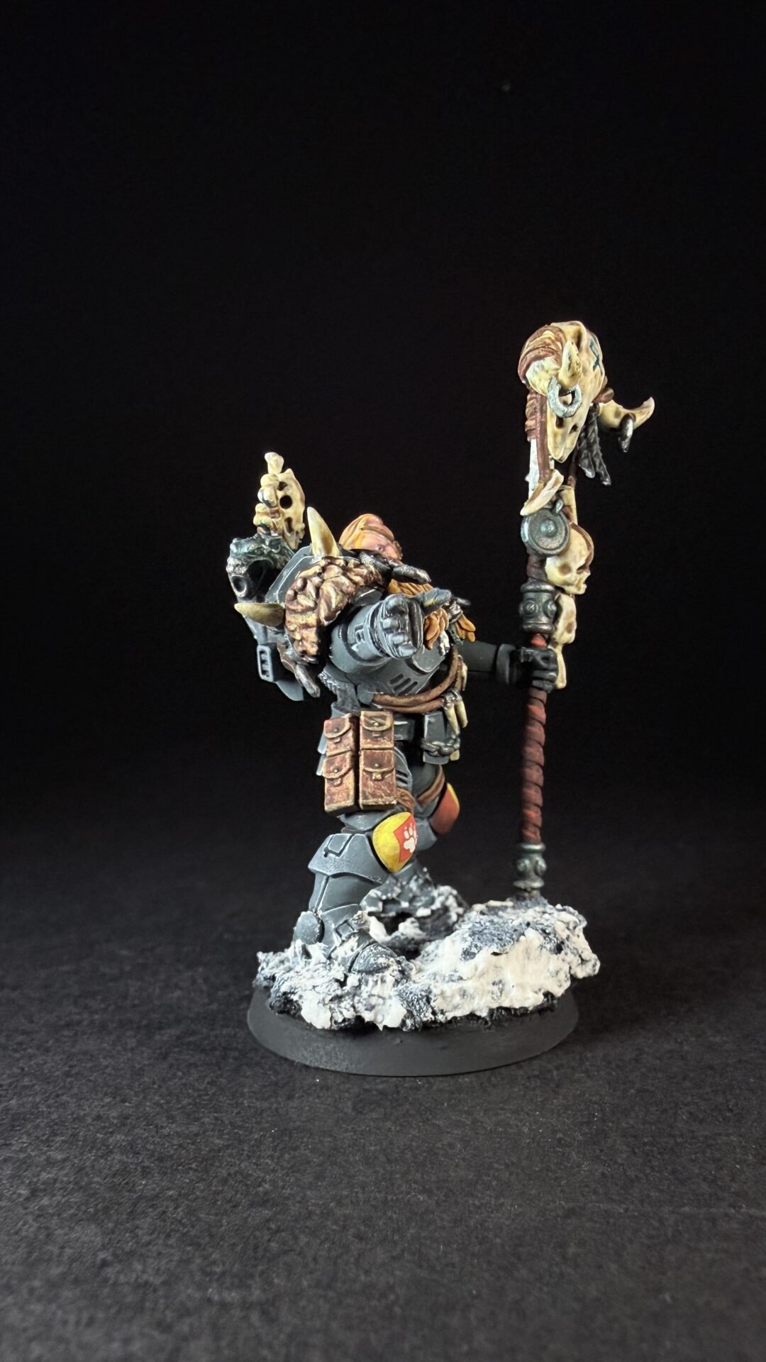 Painted Wolf Scout Rune Priest Skjald with Bolt Pistol and Runic Staff on snowy base.