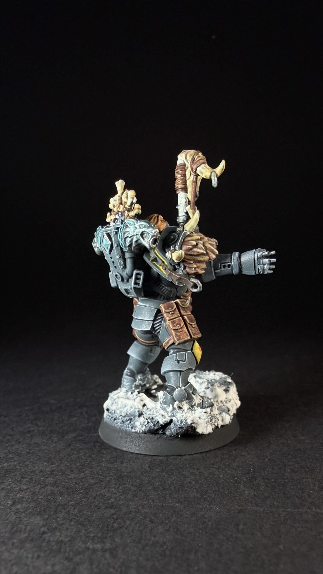Painted Wolf Scout Rune Priest Skjald with Bolt Pistol and Runic Staff on snowy base.