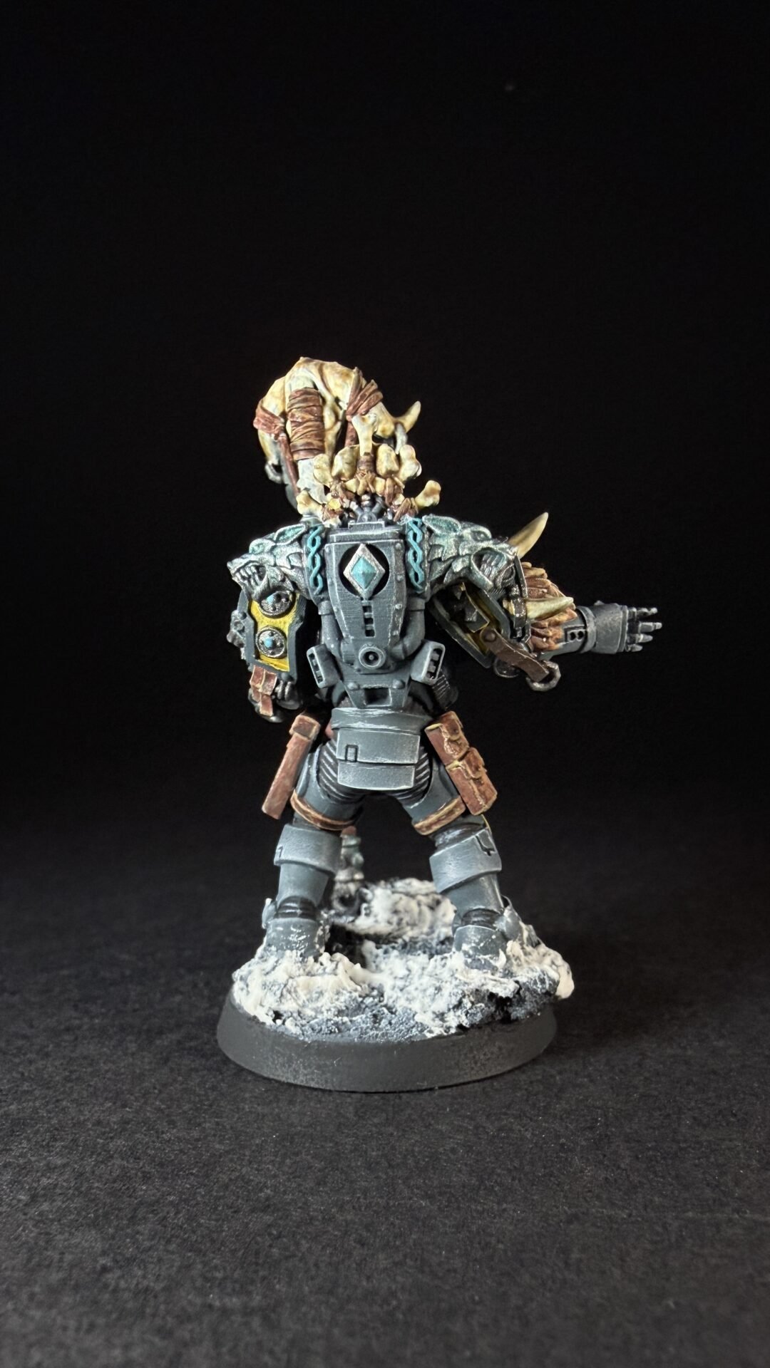 Painted Wolf Scout Rune Priest Skjald with Bolt Pistol and Runic Staff on snowy base.