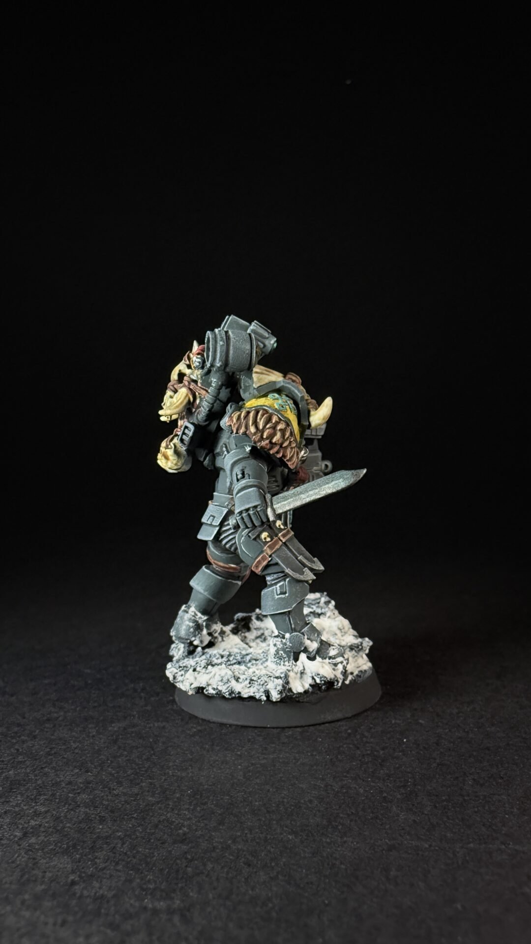 Painted Wolf Scout Fangbearer with Absolvor Bolt Pistol and Combat Blade on snowy base.