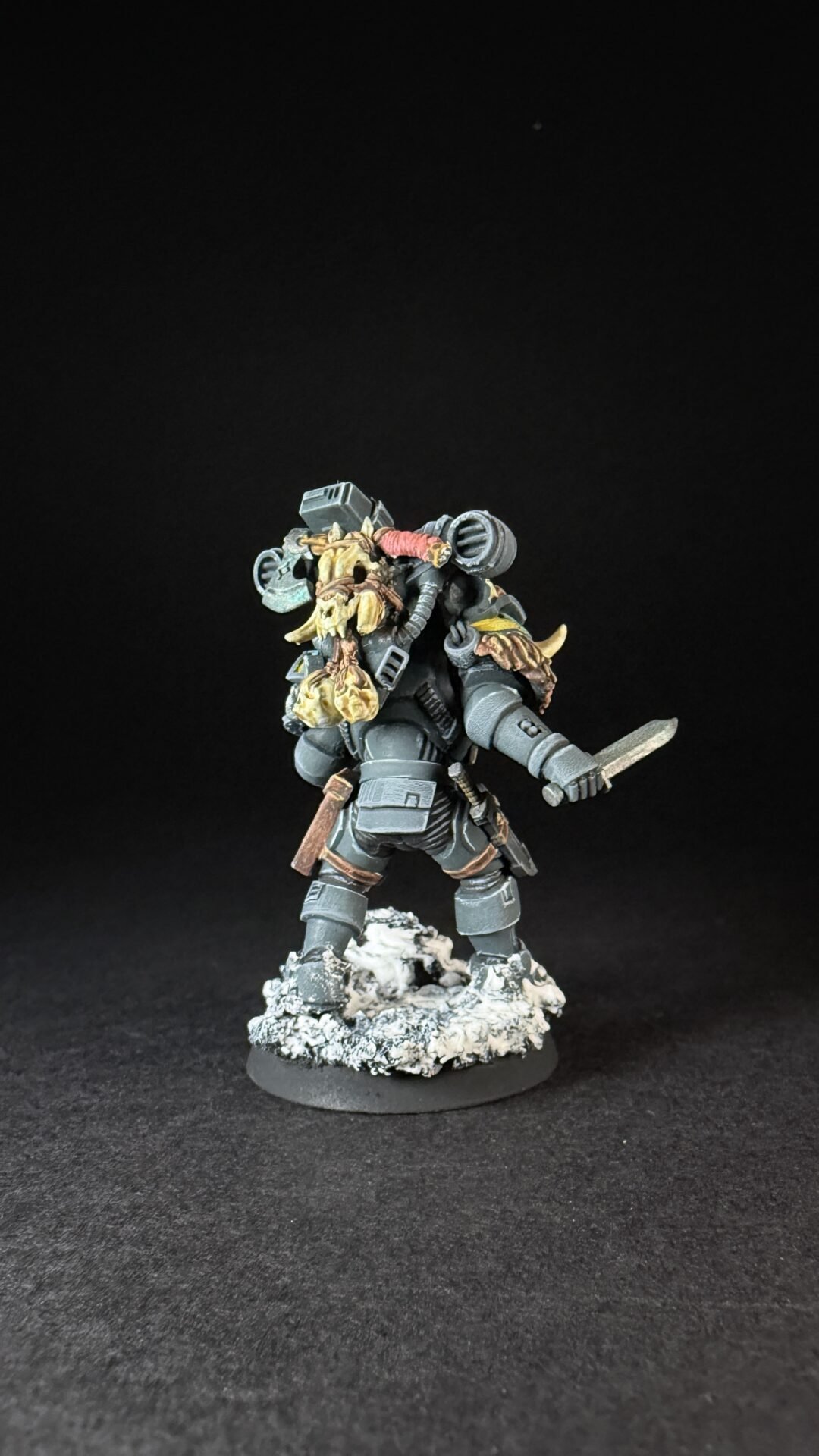 Painted Wolf Scout Fangbearer with Absolvor Bolt Pistol and Combat Blade on snowy base.