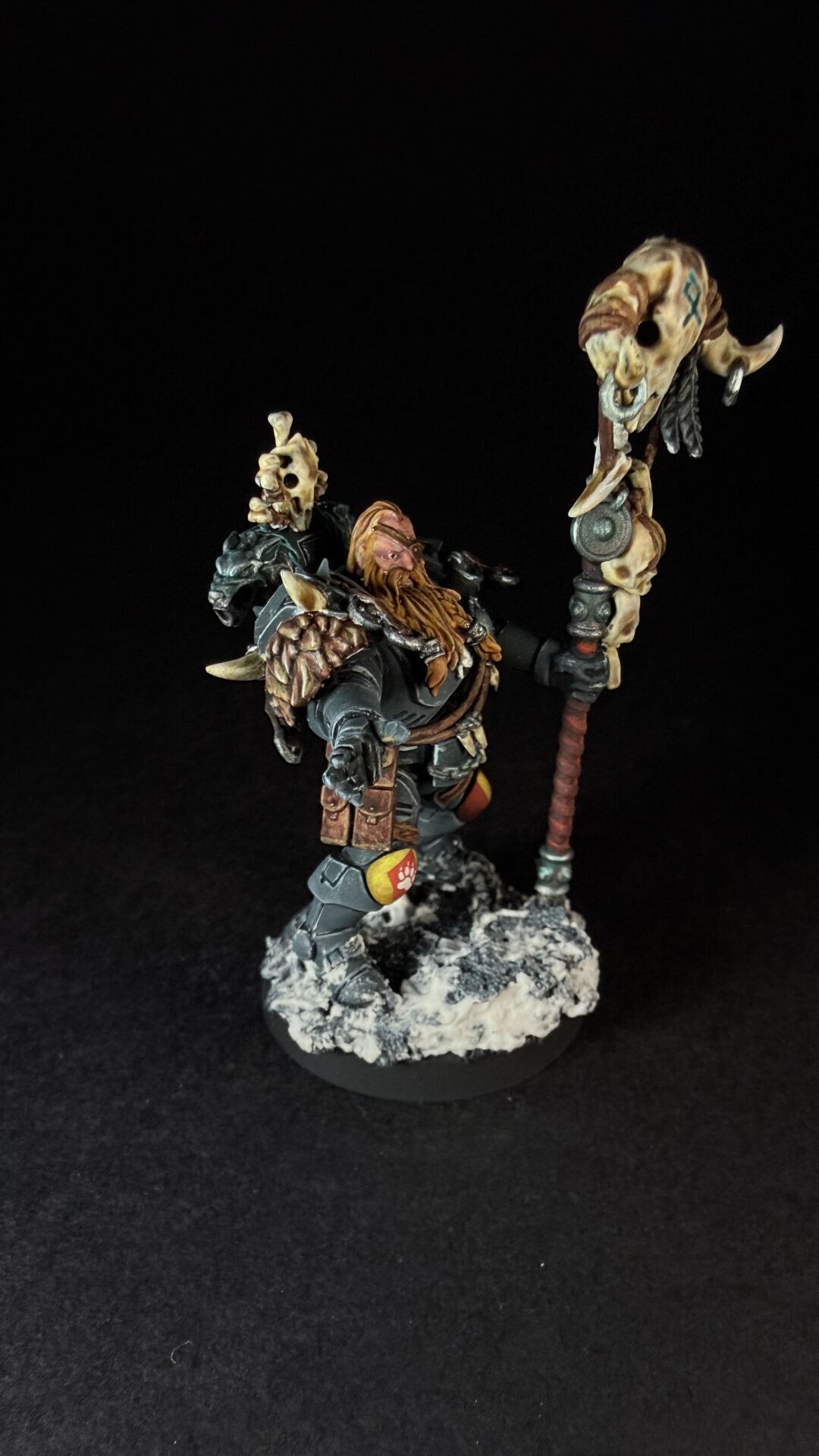 Painted Wolf Scout Rune Priest Skjald with Bolt Pistol and Runic Staff on snowy base.