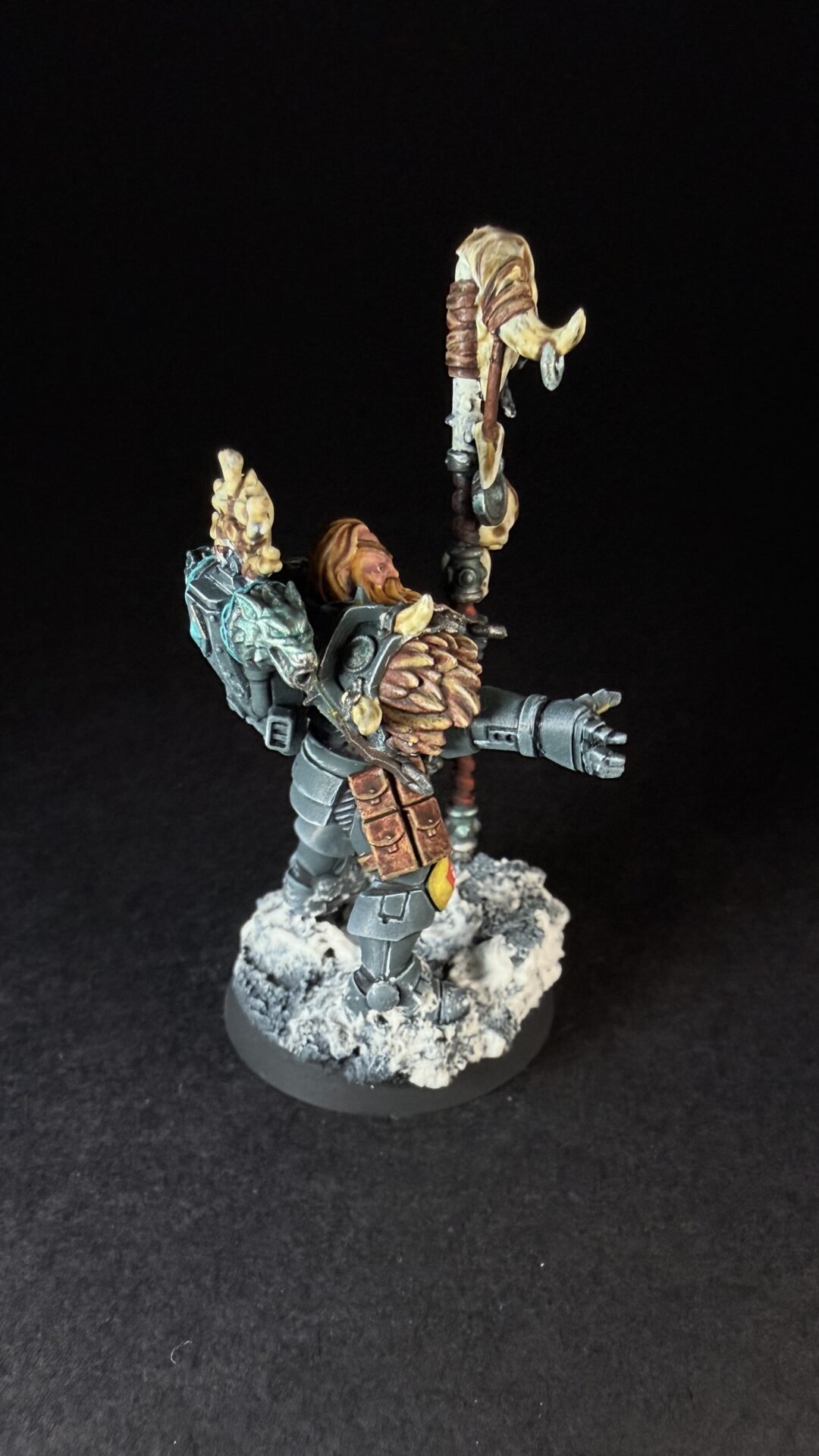 Painted Wolf Scout Rune Priest Skjald with Bolt Pistol and Runic Staff on snowy base.