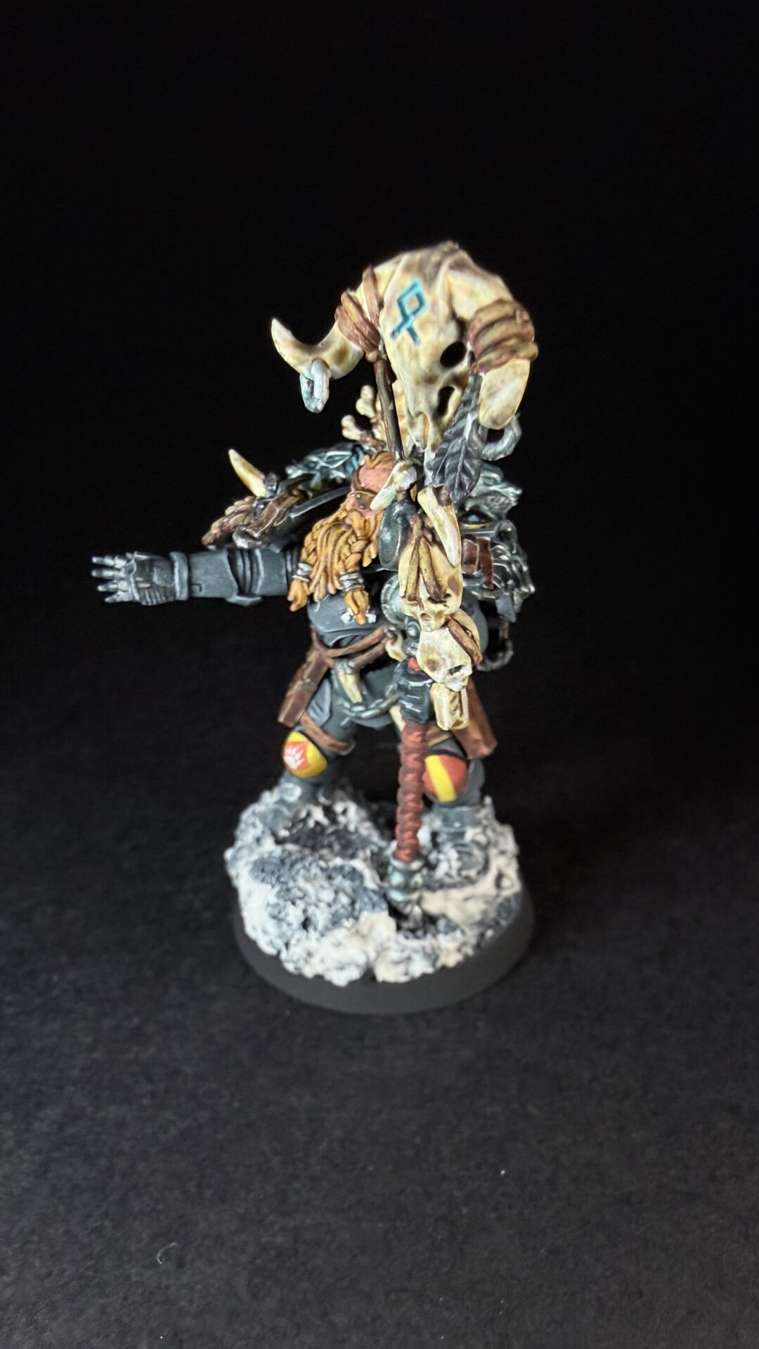 Painted Wolf Scout Rune Priest Skjald with Bolt Pistol and Runic Staff on snowy base.