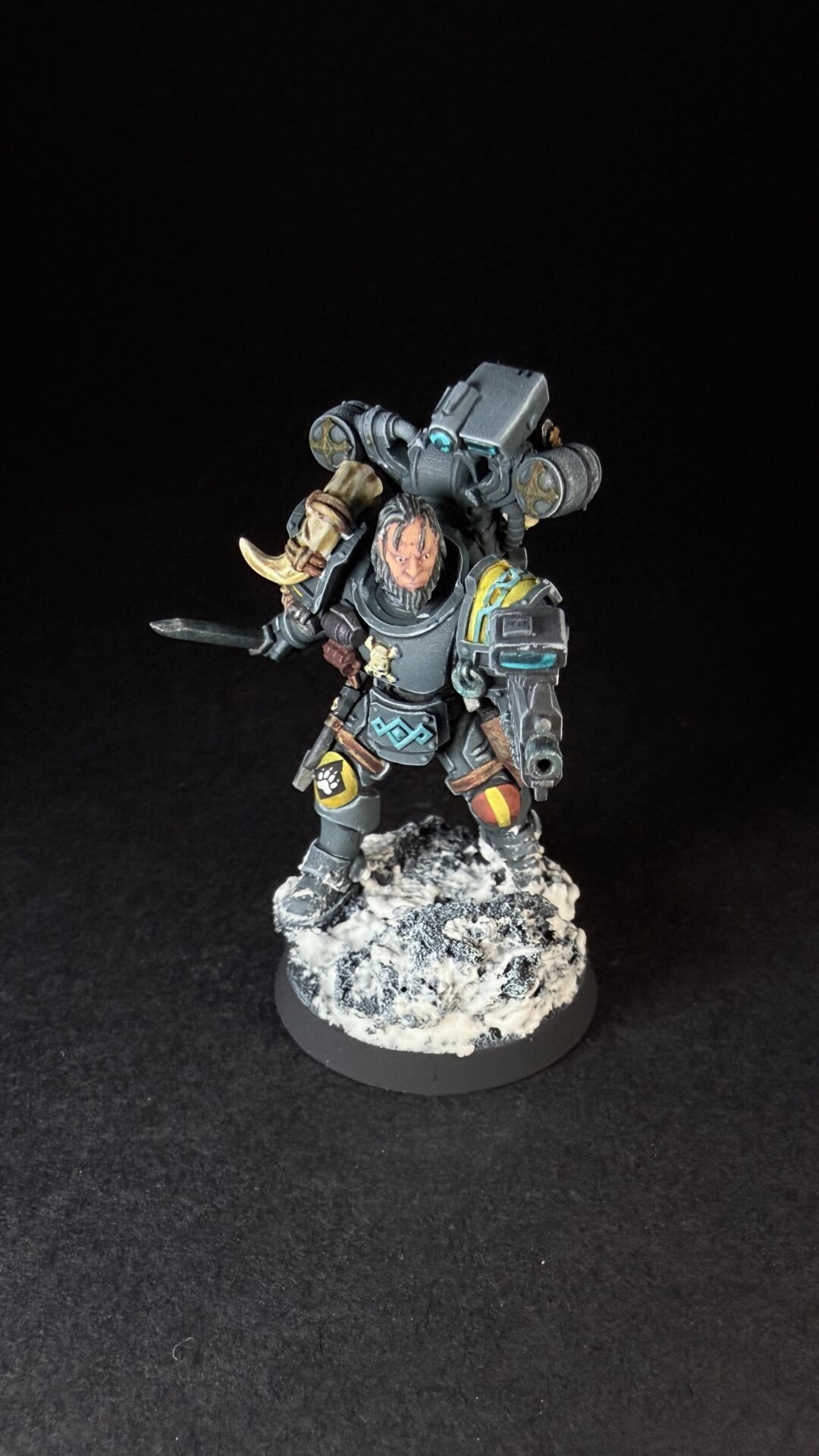 Painted Wolf Scout Fangbearer with Absolvor Bolt Pistol and Combat Blade on snowy base.