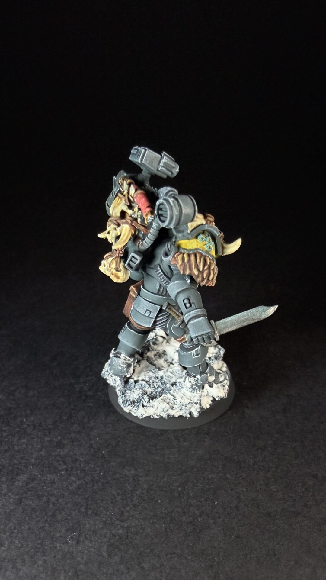 Painted Wolf Scout Fangbearer with Absolvor Bolt Pistol and Combat Blade on snowy base.