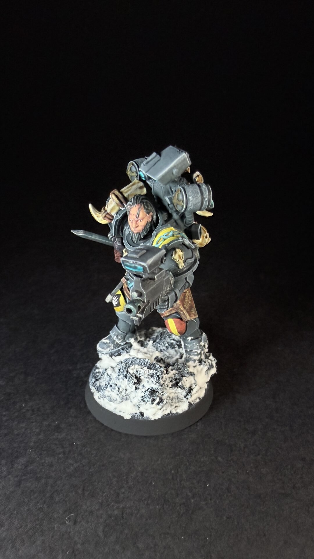 Painted Wolf Scout Fangbearer with Absolvor Bolt Pistol and Combat Blade on snowy base.